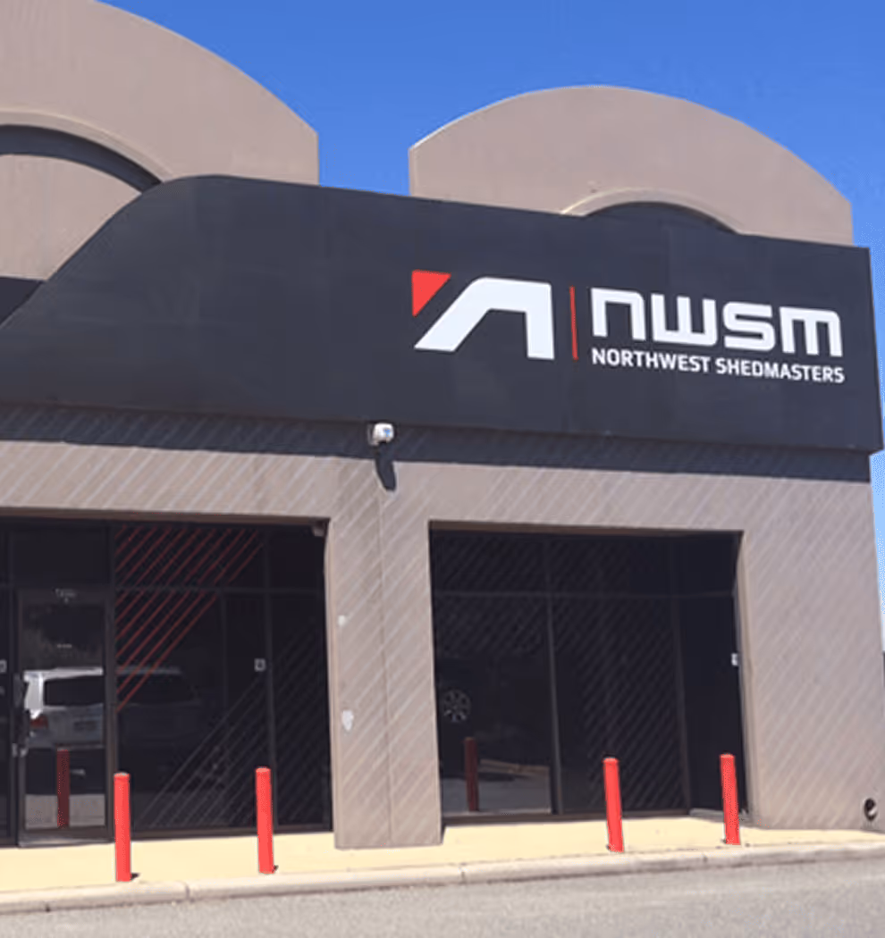 Front entrance of Northwest Shedmasters building with their logo on a black sign above.