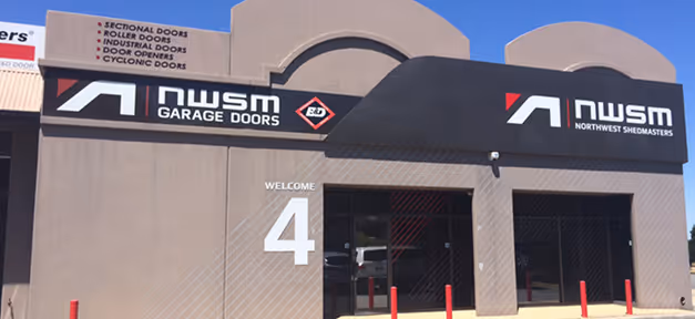 Building facade with NW Seattle Masters garage door company signage and entrance marked with large number 4.
