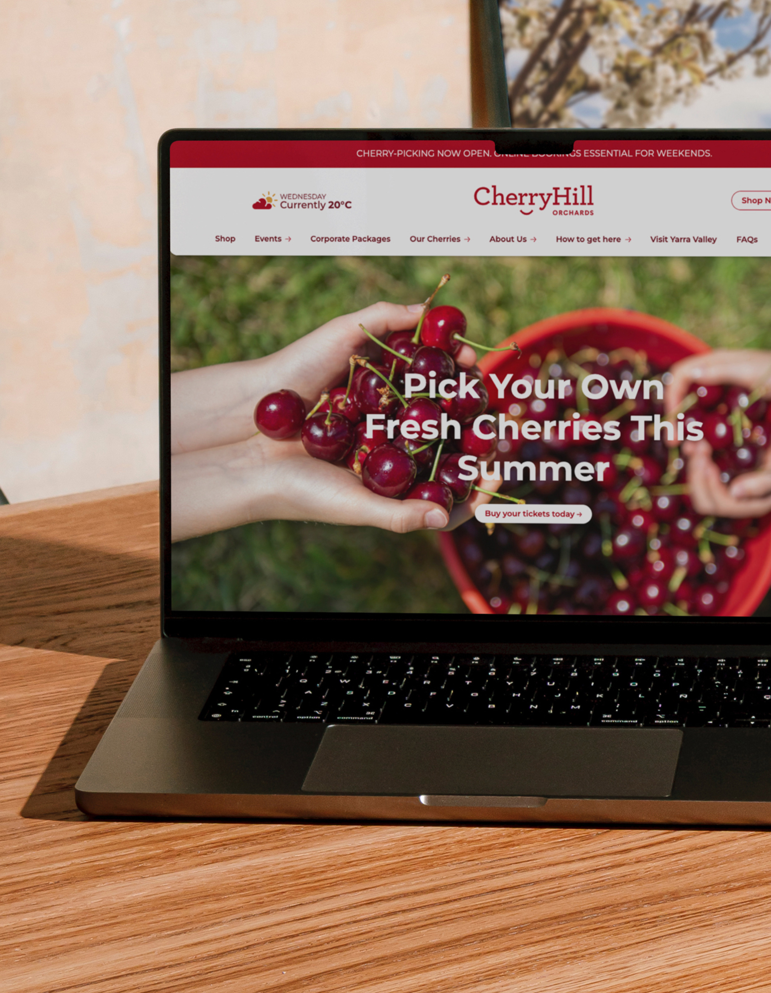 CherryHill website home page shown on an open laptop screen on a wooden table.