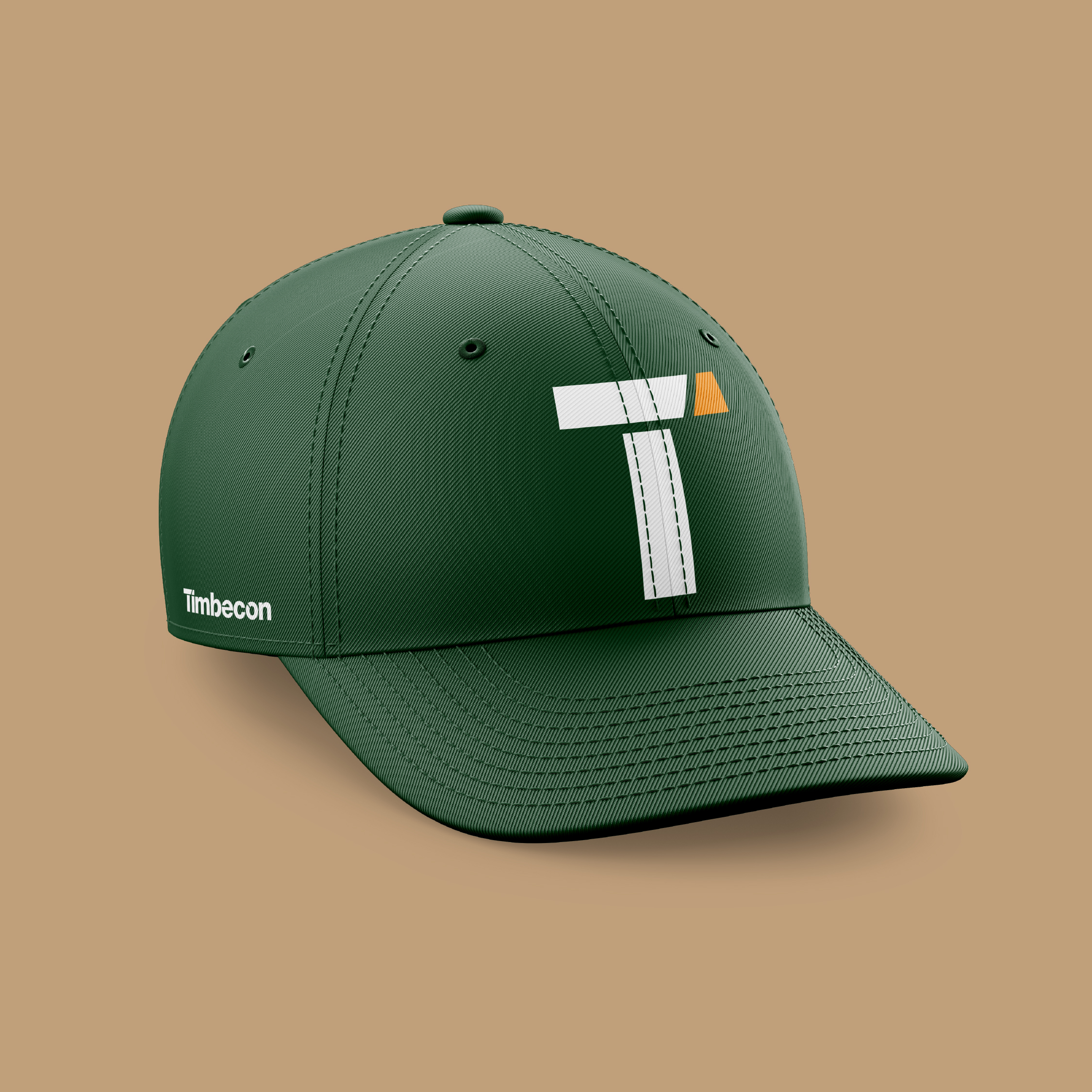 Green baseball cap on a brown background, with Timbecon 'T' on the front and full Timbecon logo on the side above ear.