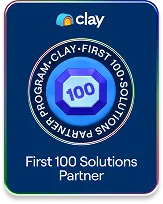 Badge showing Clay First 100 Solutions Partner with a blue octagonal emblem and surrounding text.