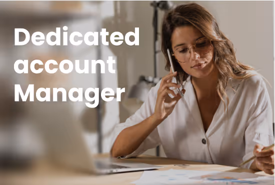 Woman with glasses on a phone call, working at a desk with papers and a laptop, with text 'Dedicated account Manager' on the left.