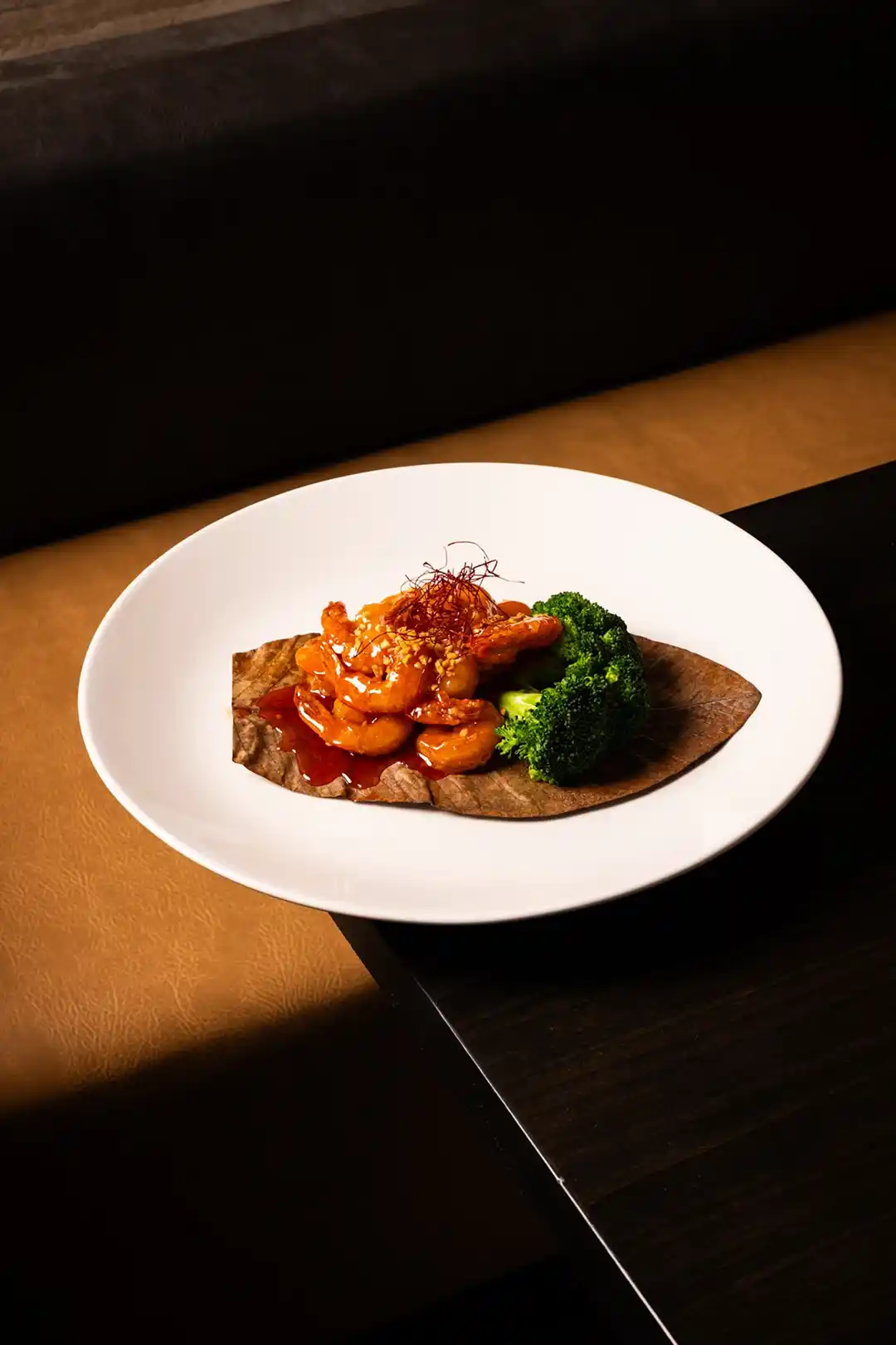 Crispy shrimp in savory sauce served with broccoli — modern Asian fusion entrée at Zen Modern Asian Bistro.
