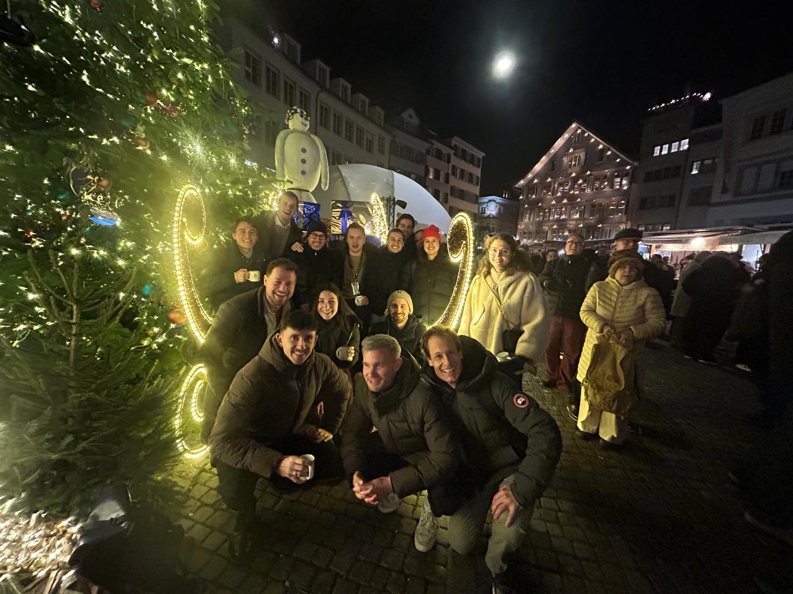 large group of people at night christmas market