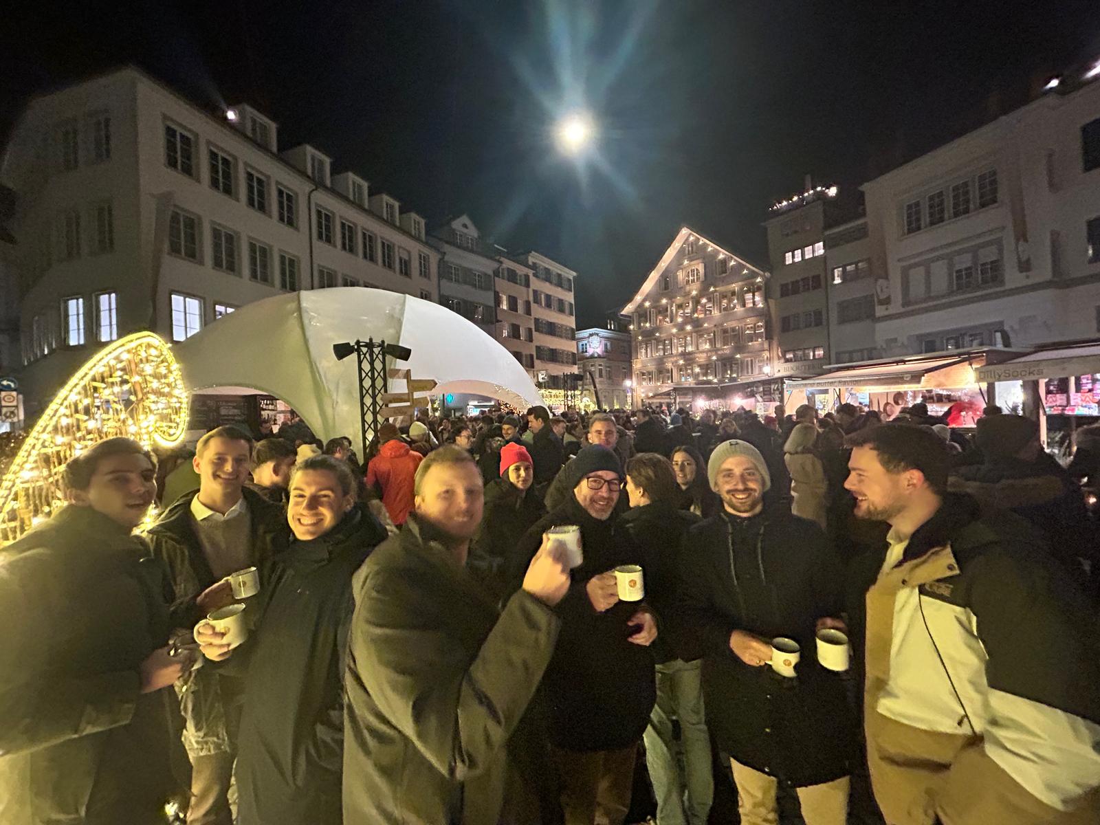 large group of people at night christmas market