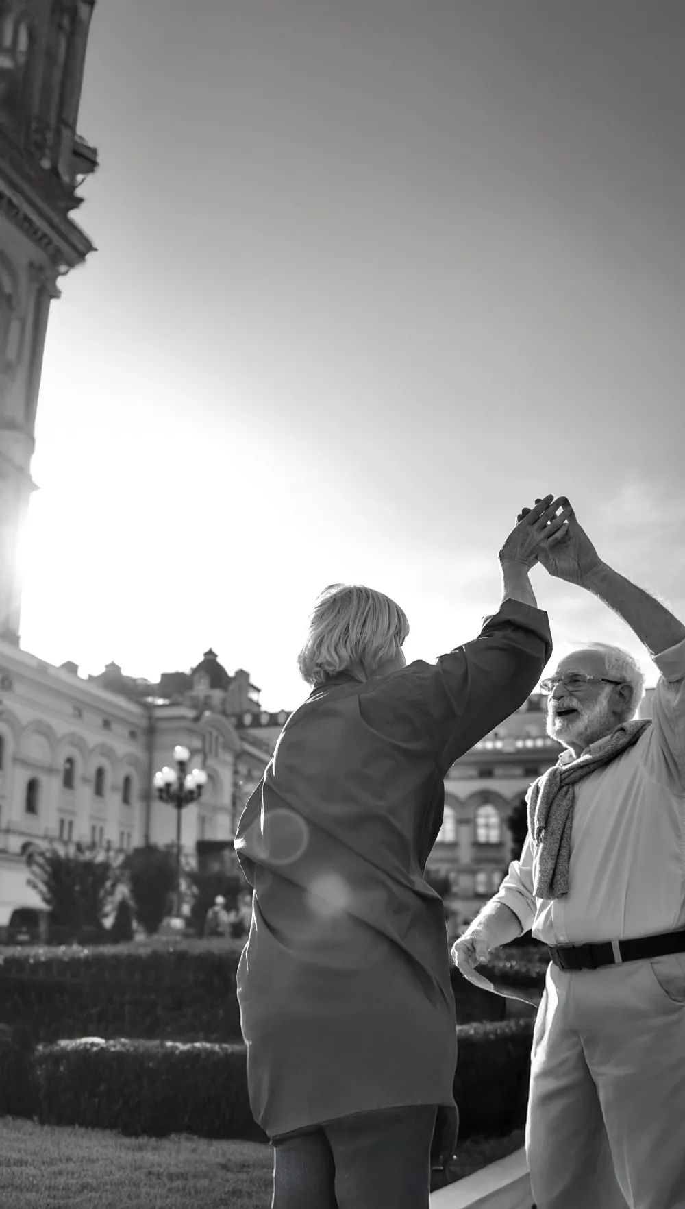 Smiling older couple dancing together outside