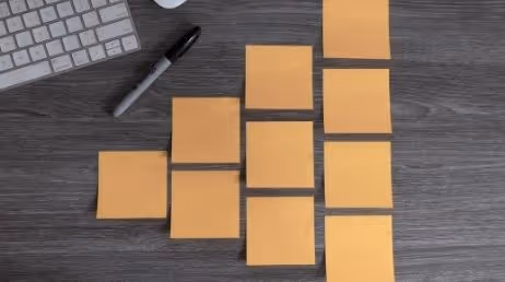 Yellow sticky notes arranged on desk for organization