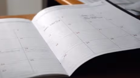 Open calendar with dates marked in a planner