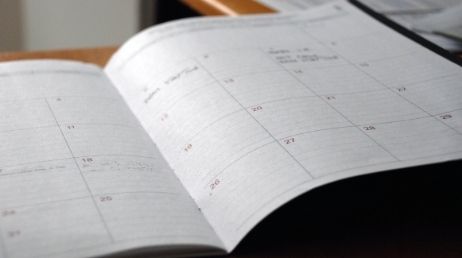 Open calendar with dates marked in a planner