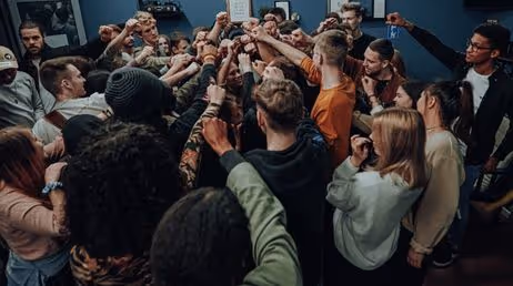 Group of people raising fists in unity at a gathering