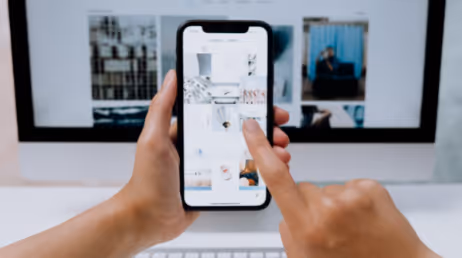 browsing photo gallery on mobile in front of desktop