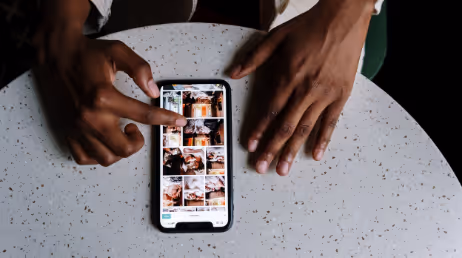 Browsing food images on mobile device at a table