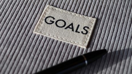Close-up of goals patch on textured fabric with pen