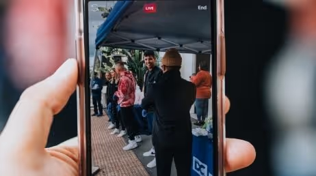 Men capturing live event on mobile phone