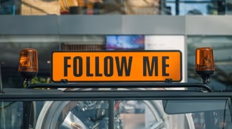 Sign that says "Follow Me" mounted on a vehicle in Airport