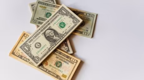 Close-up of US dollar bills on a white background