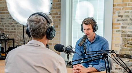 Podcast hosts recording an interview in a studio
