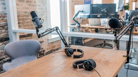 A podcast recording setup with microphones and headphones.
