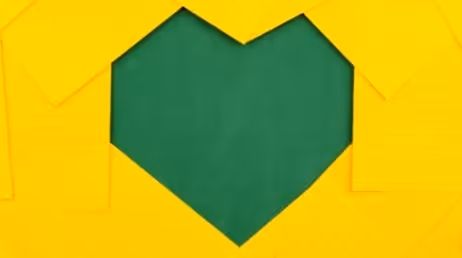 Heart-shaped cutout from yellow paper background.
