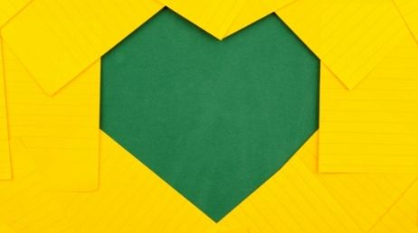 Heart-shaped cutout from yellow paper background.