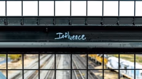 Influence graffiti on bridge railing
