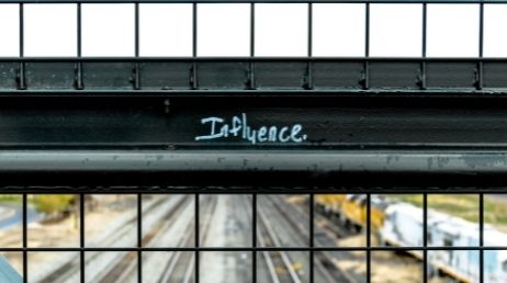 Influence graffiti on bridge railing
