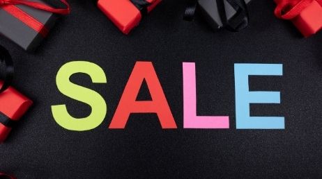 Colorful "SALE" text with gift boxes nearby