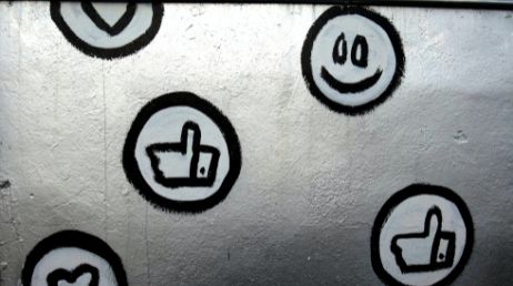 spray-painted Social media icons  on a wall