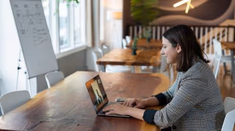 Woman in an office setting during a virtual meeting