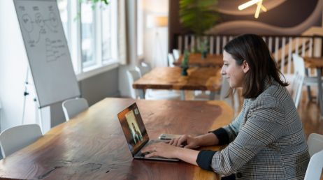 Woman in an office setting during a virtual meeting