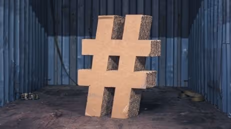 Large cardboard hashtag symbol in a shipping container