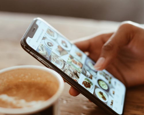 Person browsing food photos on a smartphone