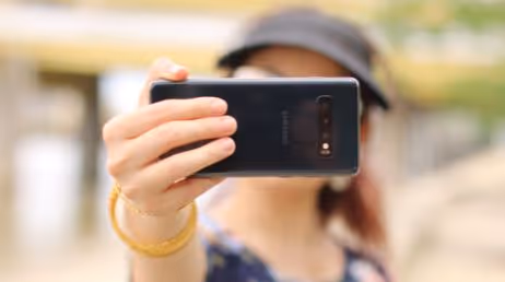 A content creator women taking some shots with smartphone