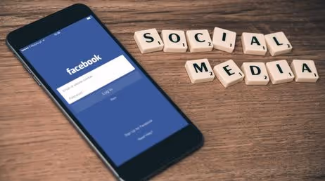 Facebook login on smartphone with social media concept text