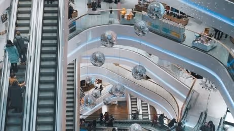 Shopping mall escalators with hanging silver globes