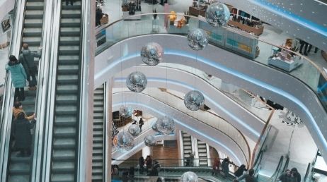 Shopping mall escalators with hanging silver globes