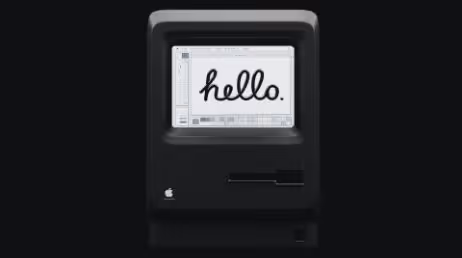 Vintage Apple Macintosh displaying hello on black screen