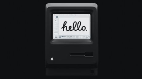 Vintage Apple Macintosh displaying hello on black screen