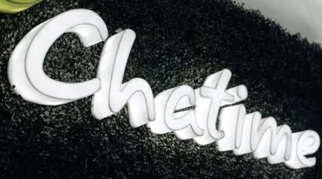 Chatime logo sign with green textured background