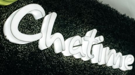 Chatime logo sign with green textured background