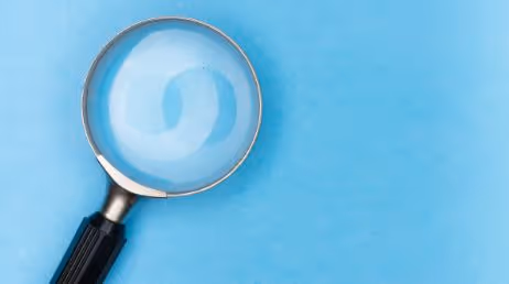 A magnify glass on a sky blue background