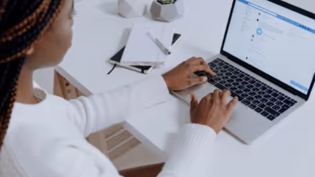 Woman using laptop to chat on a social platform