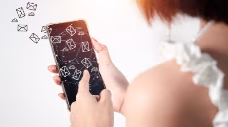 Person using phone with email icons overlay