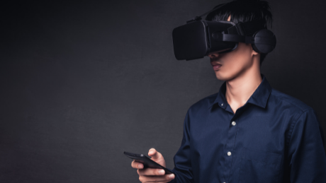 Person using VR headset and smartphone