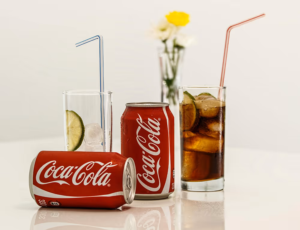 Refreshing Coca-Cola drinks with ice and lime
