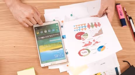 Person analyzing charts with a tablet