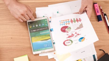 Person analyzing charts with a tablet