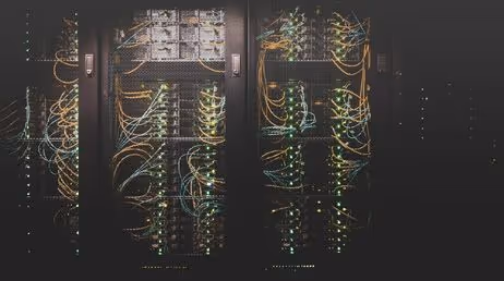 Server room with illuminated networking cables"