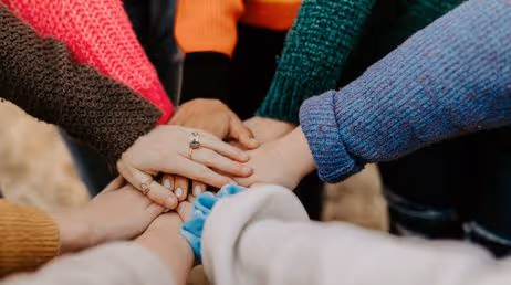 Group teamwork with hands stacked together