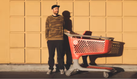Person standing with a shopping cart outside store